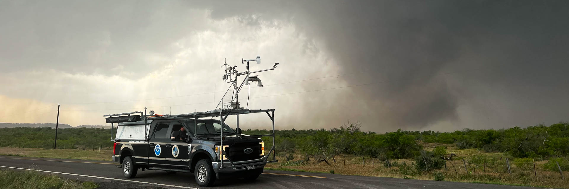Truck with instruments mounted to the roof, in front of a tornado